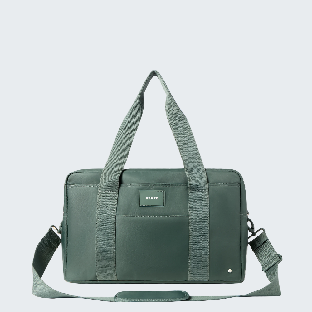 Green duffel bag with shoulder strap on a white background
