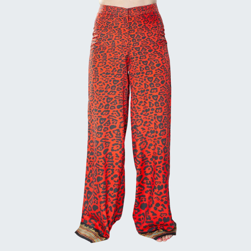 Red leopard print pants with gold trim on a white background