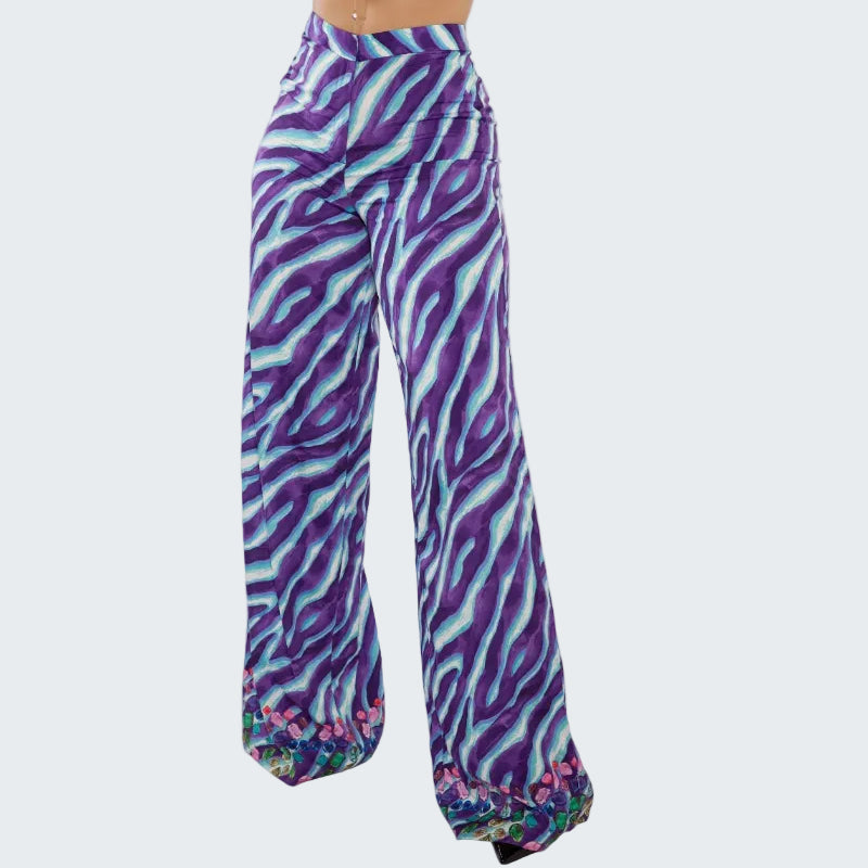 Purple and blue zebra print pants on a white background