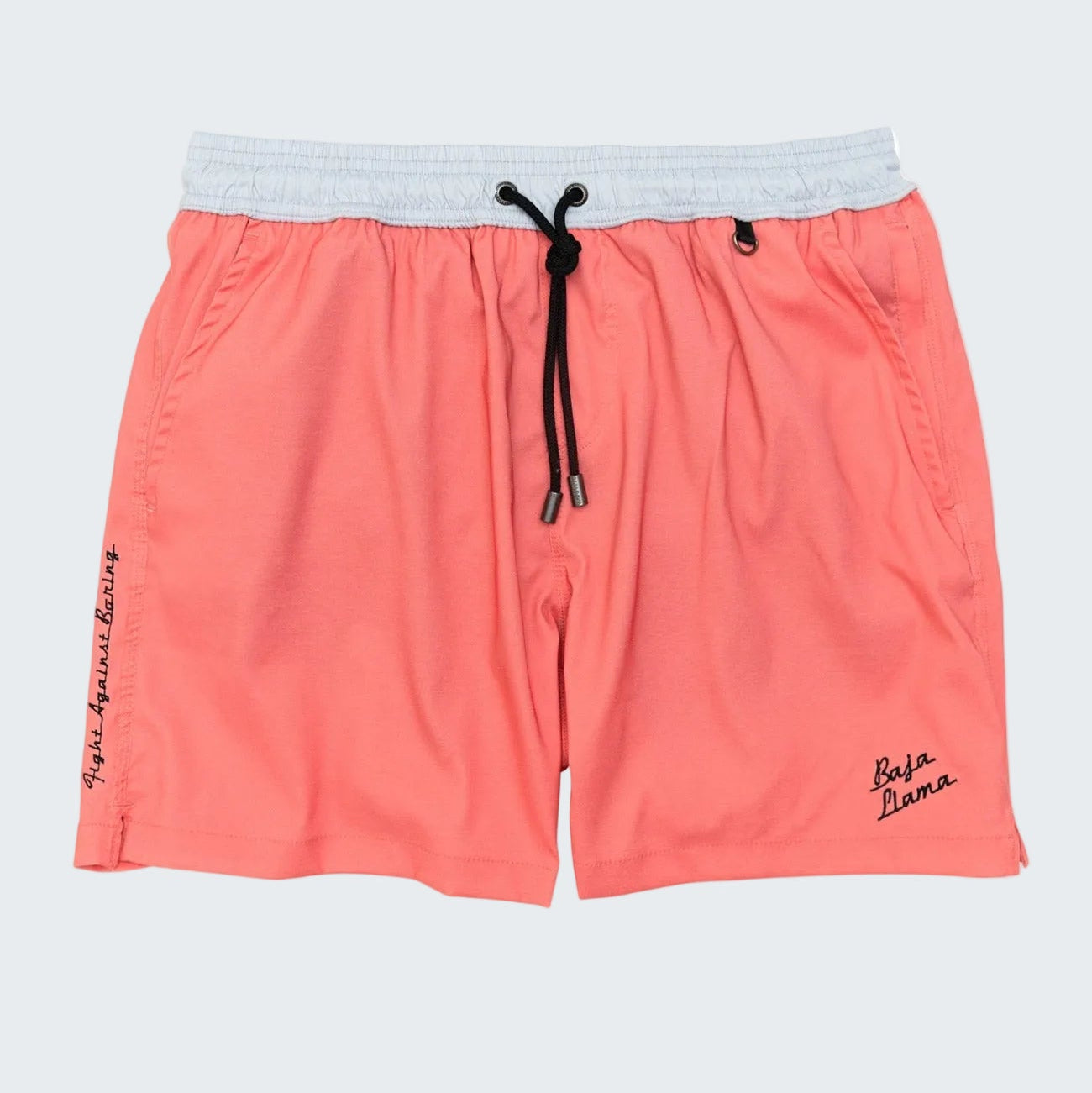 Coral pink athletic shorts with a light gray elastic waistband, black drawstring, and small black script logos on the sides, shown against a plain white background.