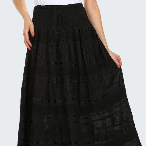 Woman wearing a black lace skirt over a white top on a white background