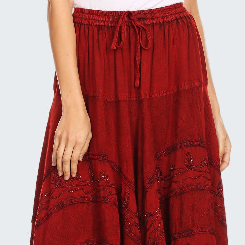 Red patterned skirt worn by a person on a white background