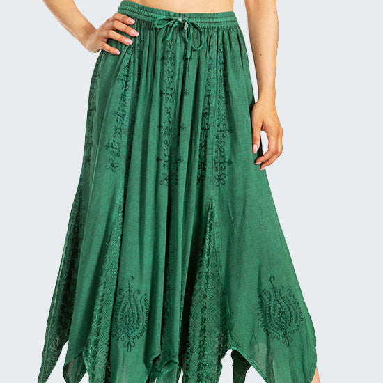 Woman wearing a white crop top and green lace skirt on a white background