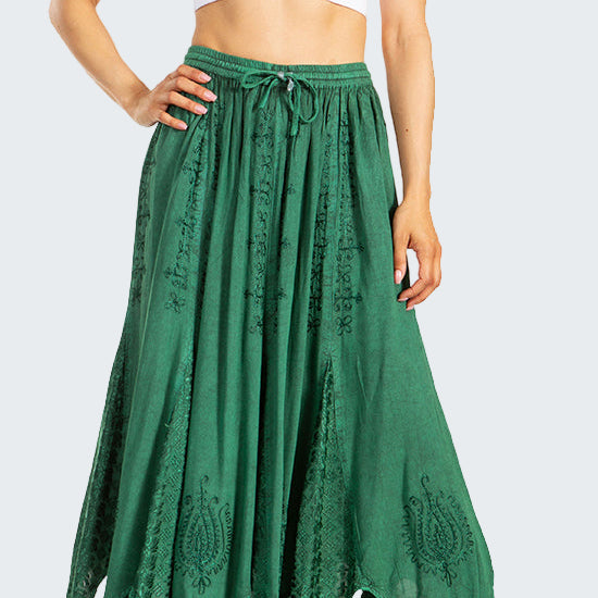Woman wearing a white crop top and green lace skirt on a white background