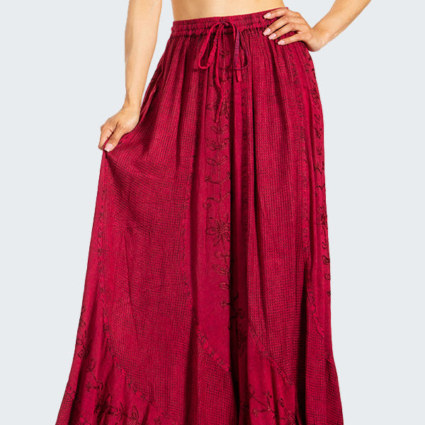 Woman wearing a white crop top and red skirt on a white background