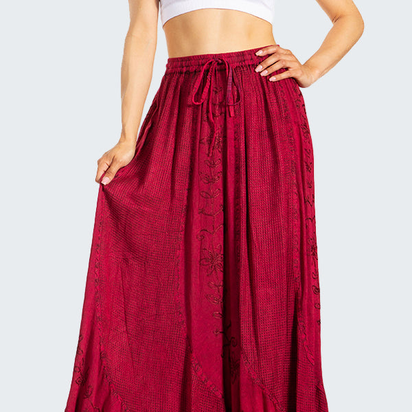 Woman wearing a white crop top and red skirt on a white background