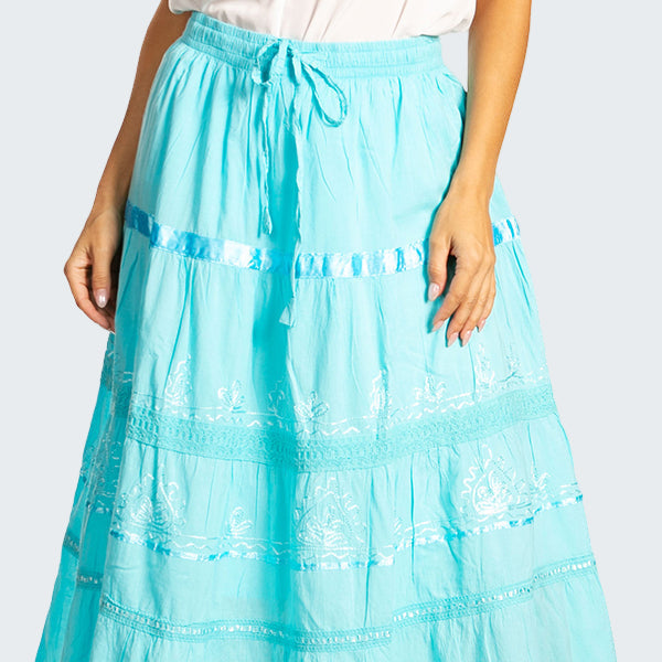 Light blue lace skirt worn by a person on a white background