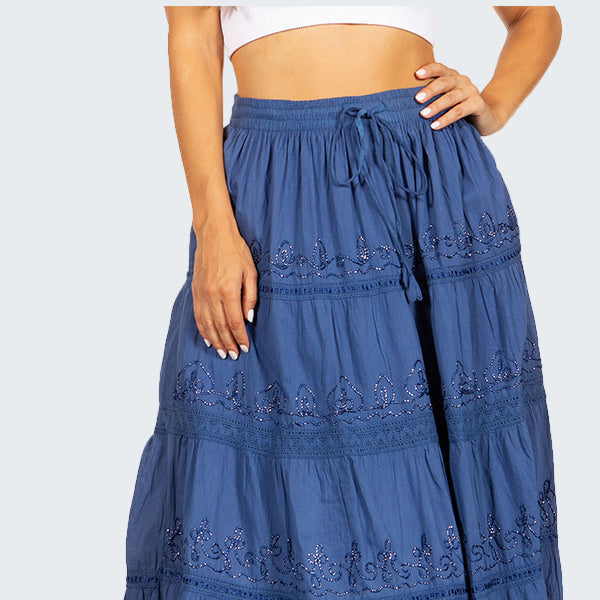 Blue tiered skirt with lace details worn by a person on a white background