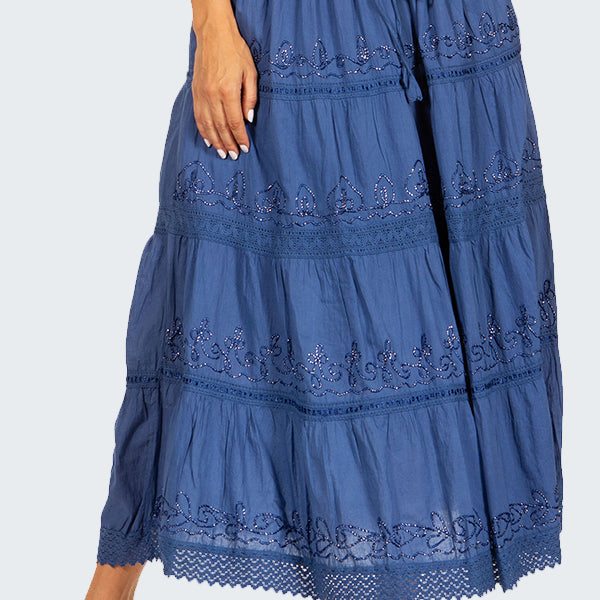 Blue tiered skirt with lace details worn by a person on a white background