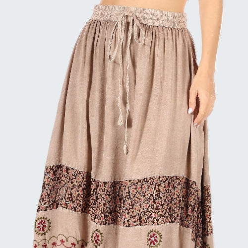 Beige long skirt with floral patterns on a white background