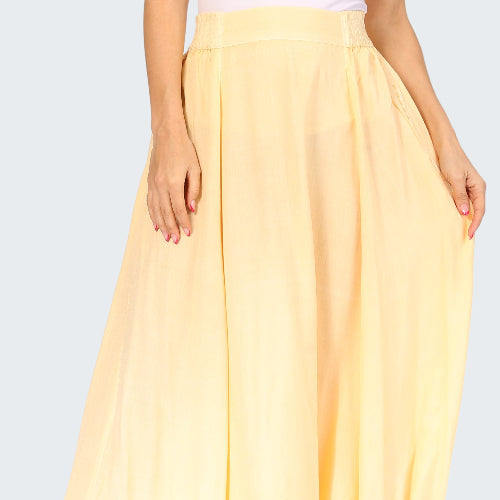 Yellow skirt worn by a person on a white background