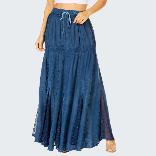 Woman wearing a white crop top and blue denim skirt on a white background