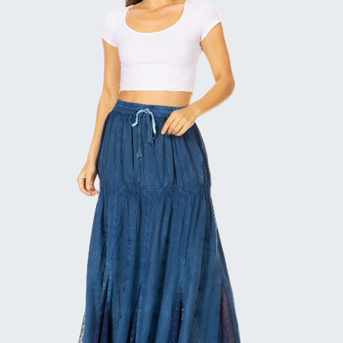 Woman wearing a white crop top and blue denim skirt on a white background