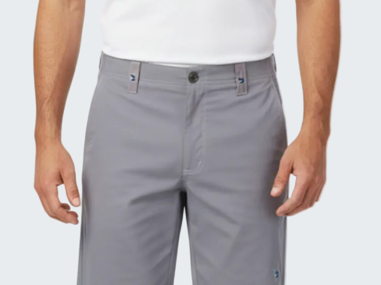 Person wearing gray shorts and a white shirt on a white background