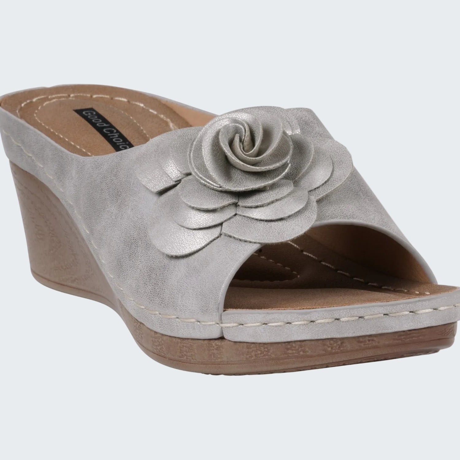 Gray wedge sandal with a floral design on a white background