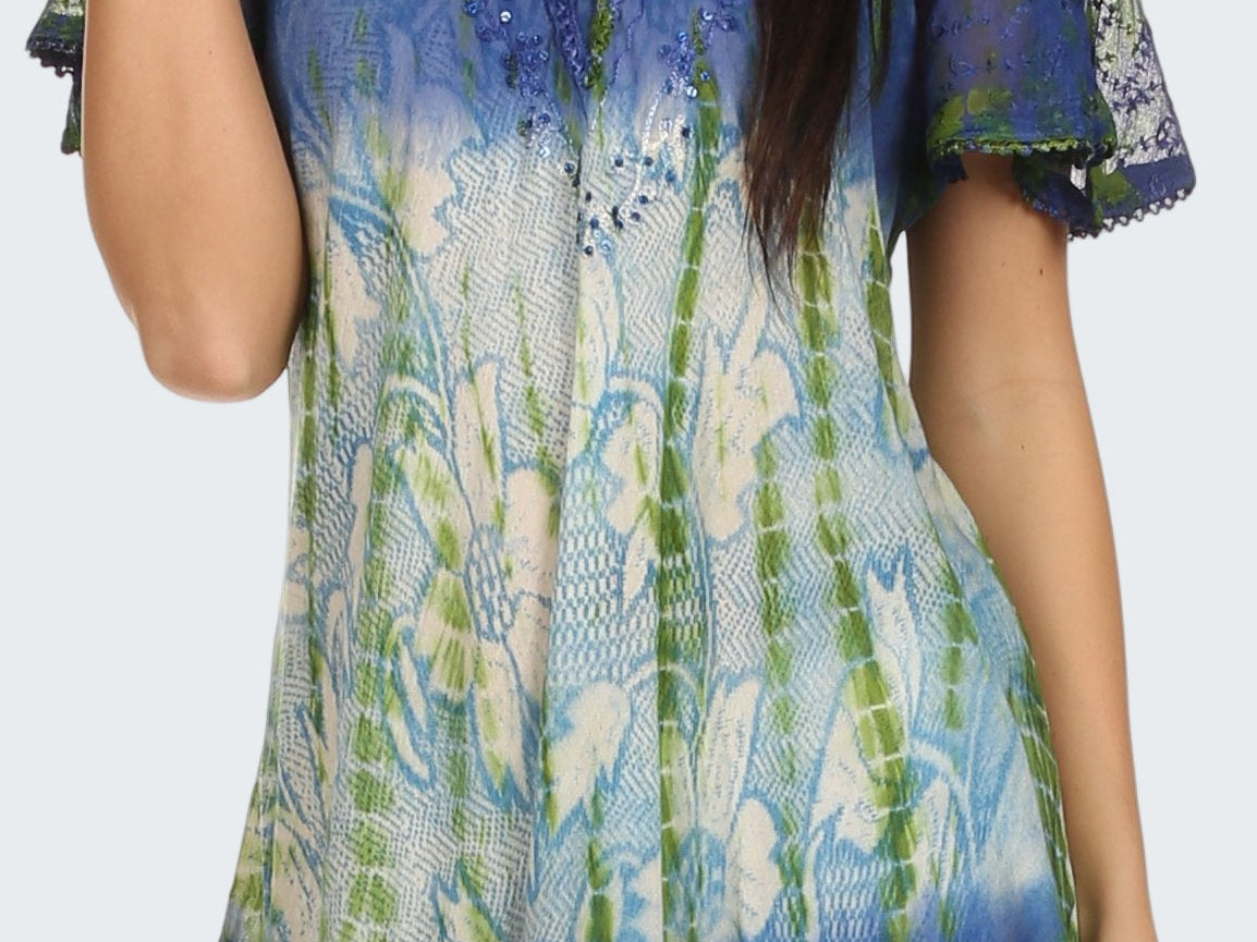 Woman wearing a colorful patterned top with short sleeves on a white background