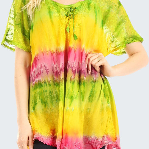 Woman wearing a colorful tie-dye shirt with green, yellow, and pink hues on a white background.