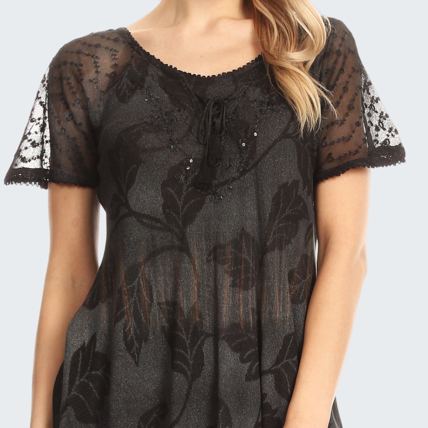Black lace top worn by a model on a white background