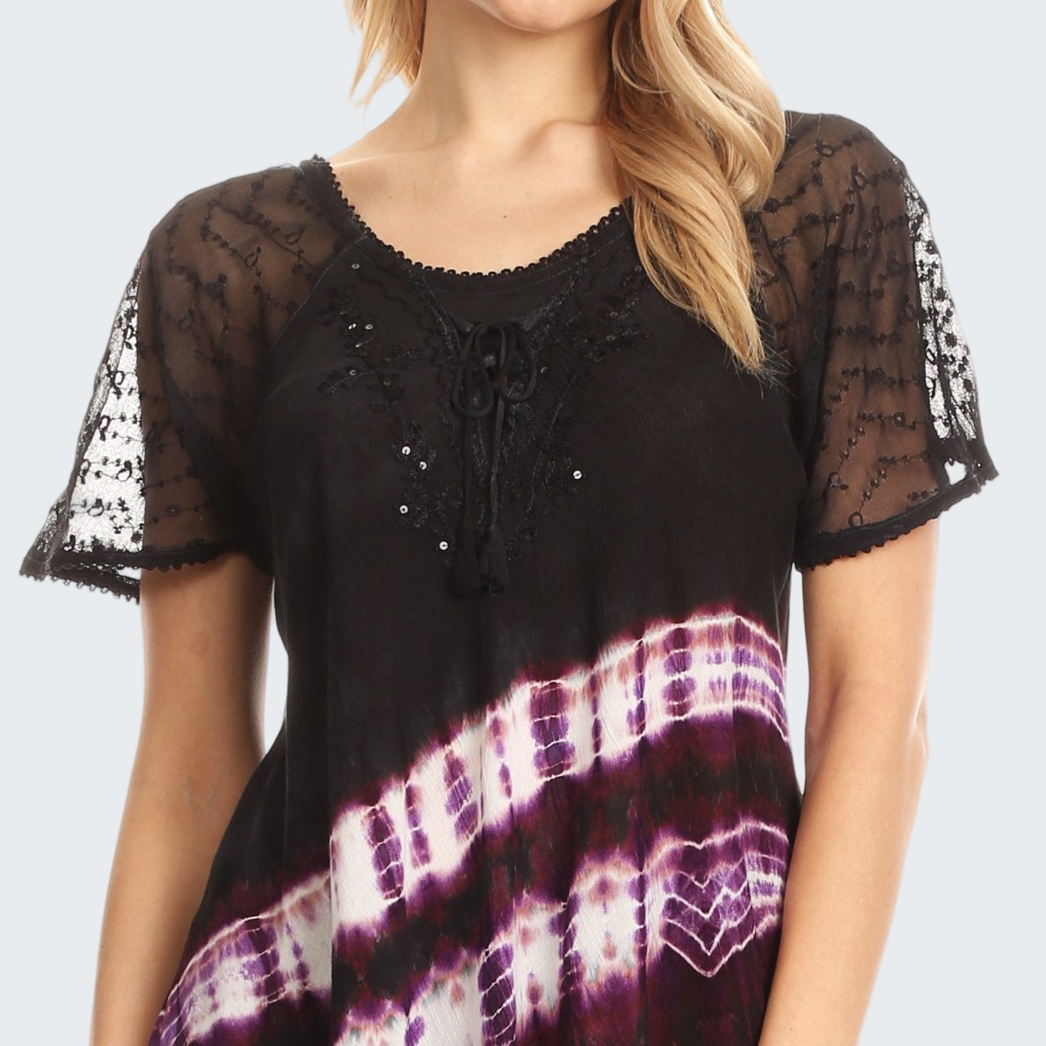 Black lace top with tie-dye pattern worn by a model