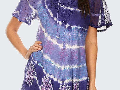 Woman wearing a purple tie-dye shirt with floral patterns on a white background