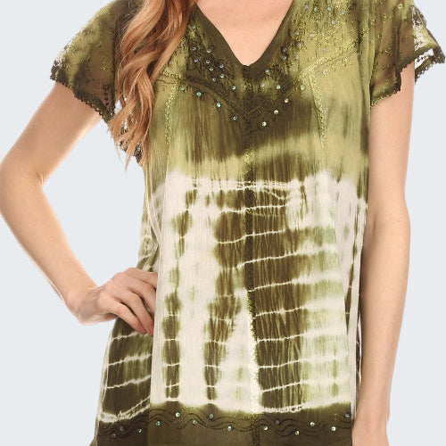 Woman wearing a green tie-dye top with black lace trim on a white background