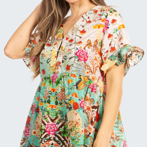 Woman wearing a colorful floral blouse on a white background