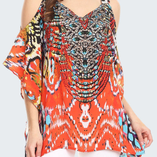 Woman wearing a colorful patterned top with a white background