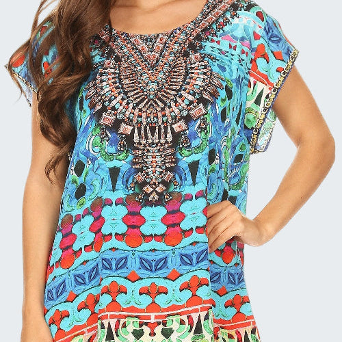 Woman wearing a colorful patterned dress with intricate designs.