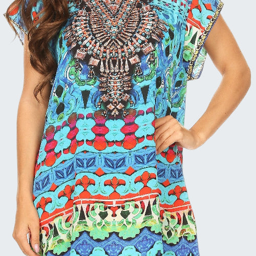 Woman wearing a colorful patterned dress with intricate designs.