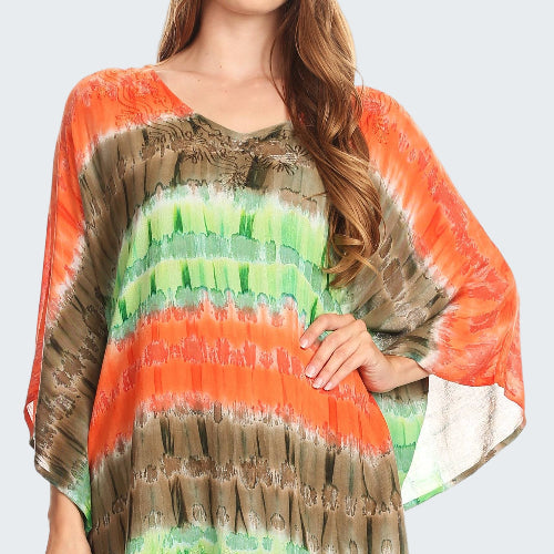 Woman wearing a colorful tie-dye poncho with orange, green, and brown patterns.