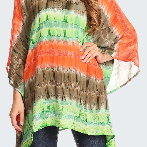 Woman wearing a colorful tie-dye poncho with orange, green, and brown patterns.