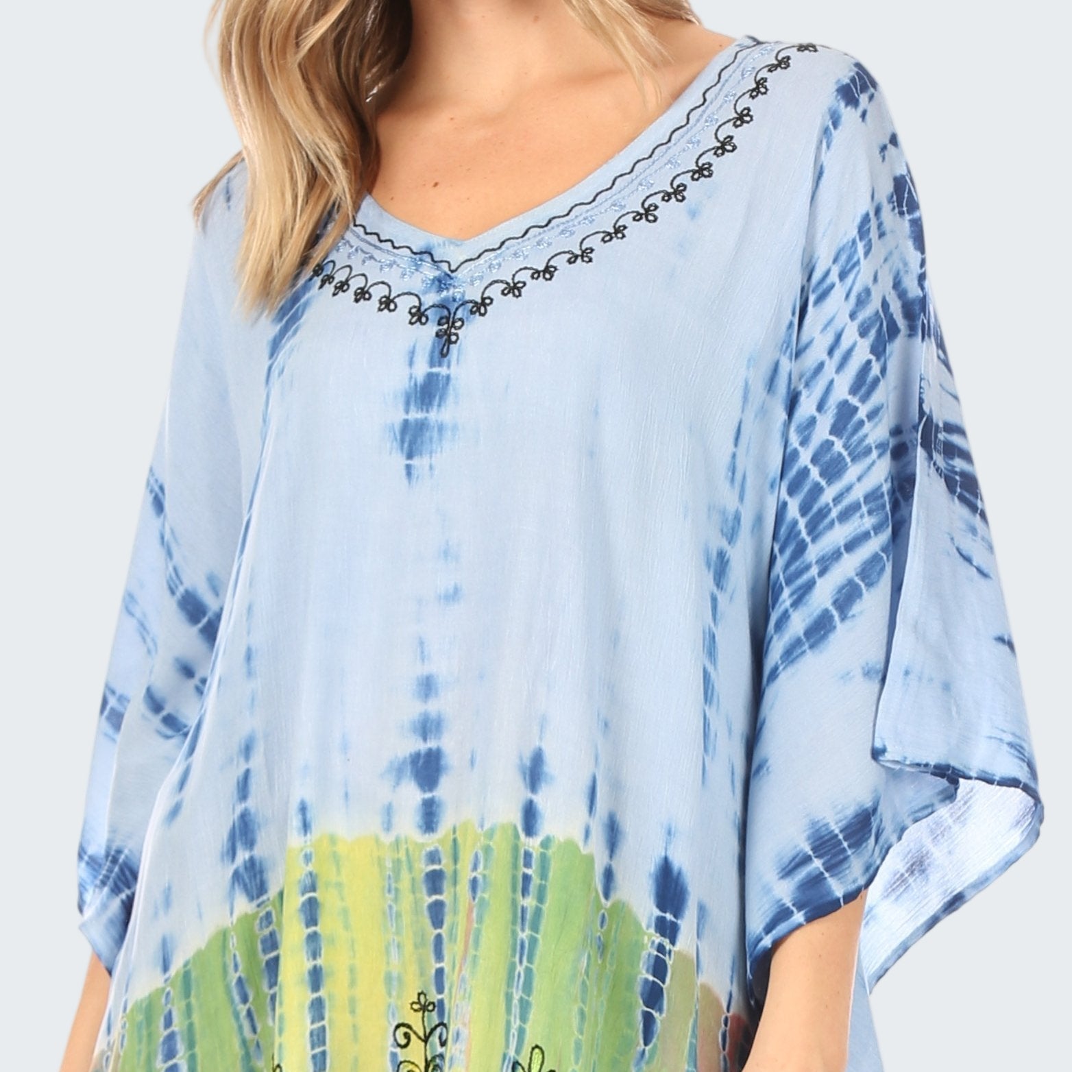 Blue and green tie-dye poncho with embroidery on a white background