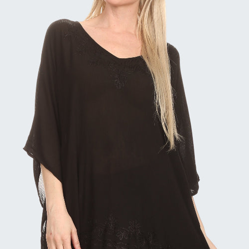 Black poncho worn by a person on a white background