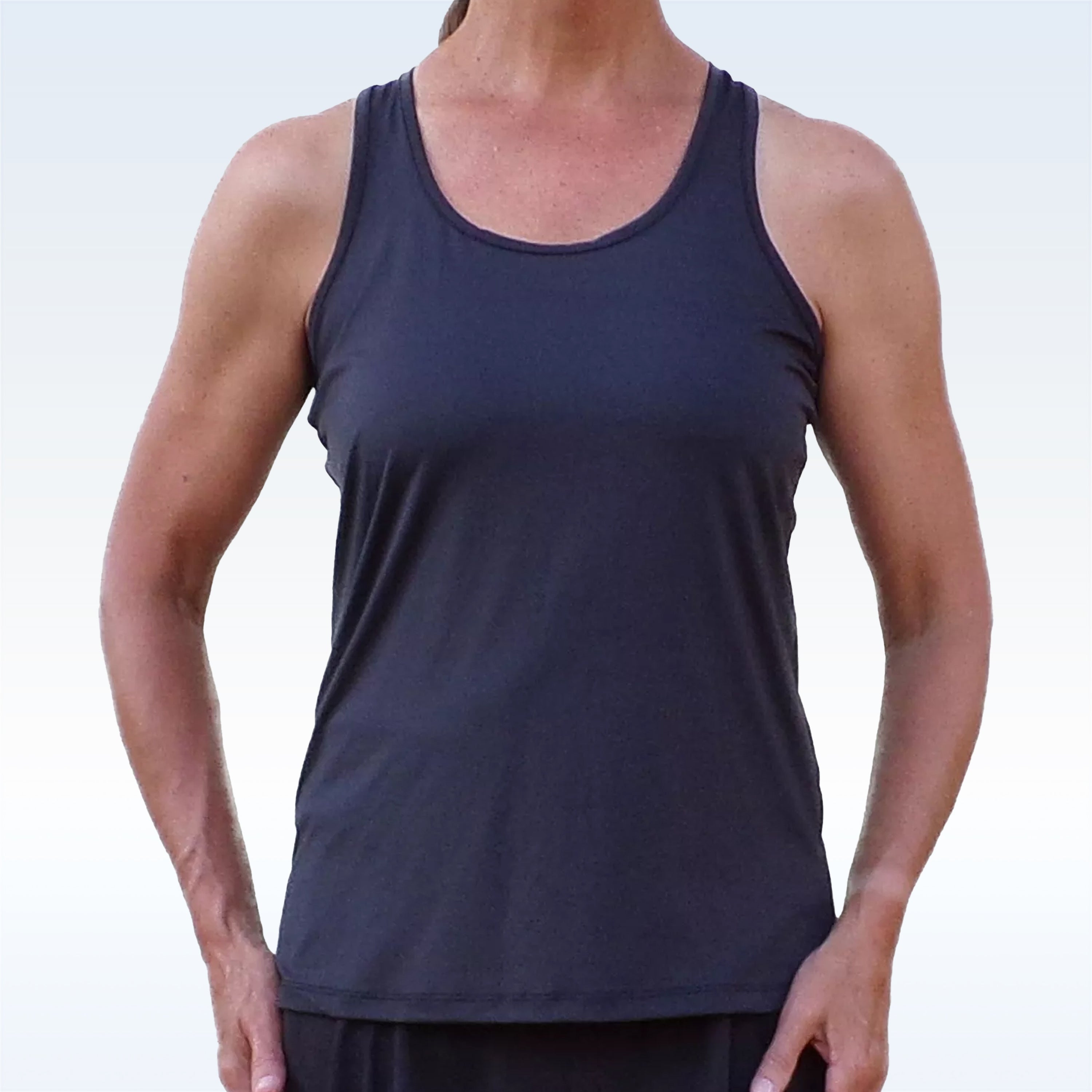 Person wearing a navy tank top against a light gray background