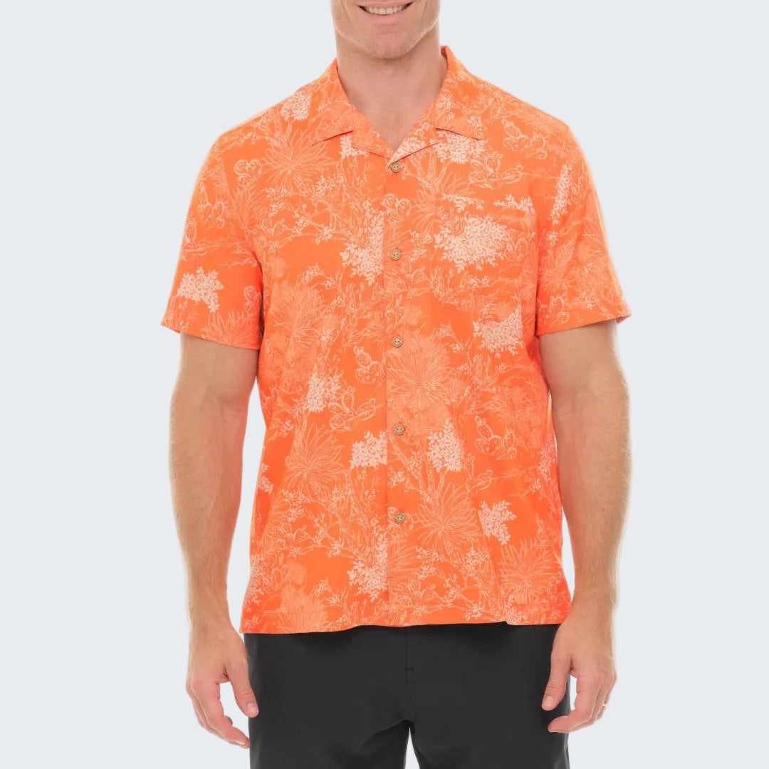 Man wearing an orange patterned shirt on a white background