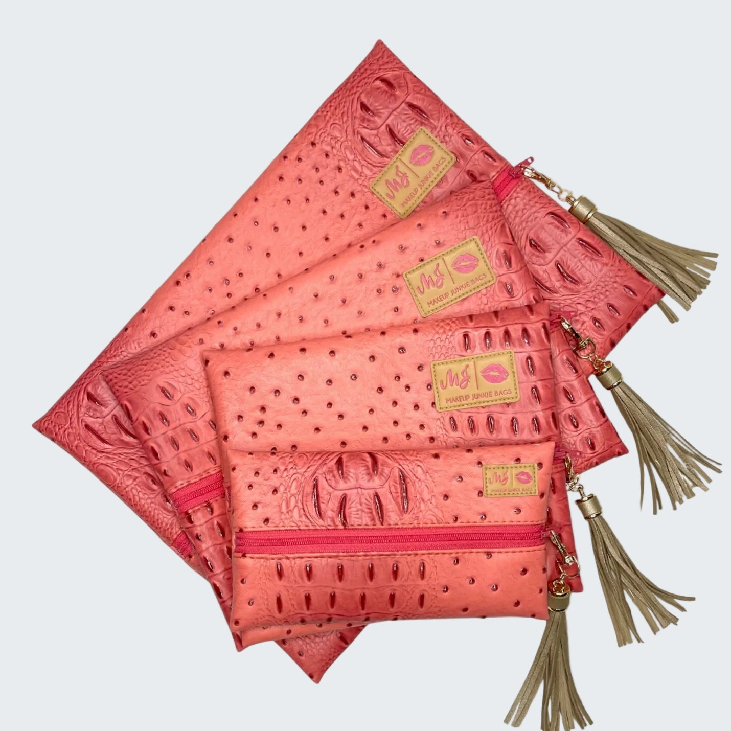 Set of pink pouches with tassels on a white background