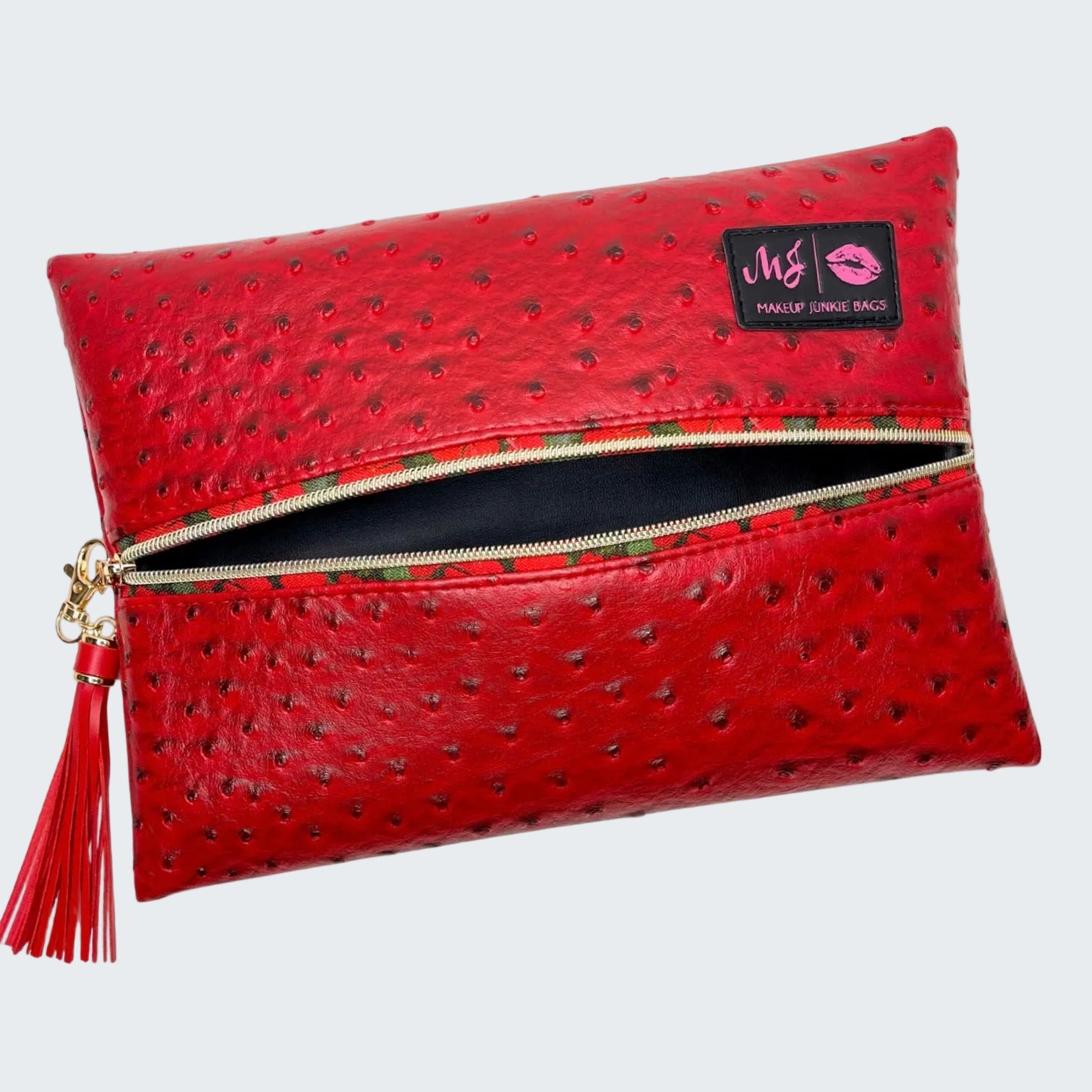Red clutch bag with a visible brand label on a white background