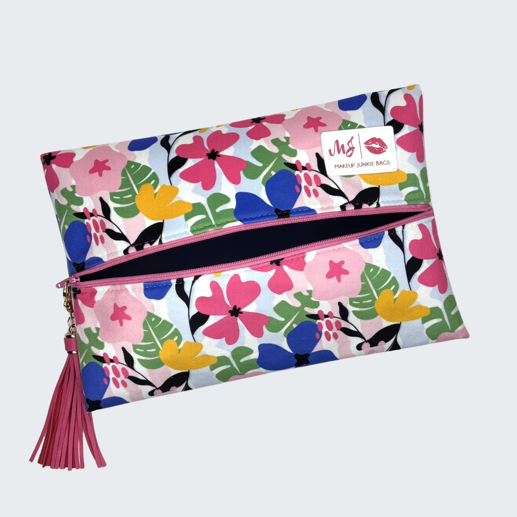 Floral patterned pouch with a tassel on a white background