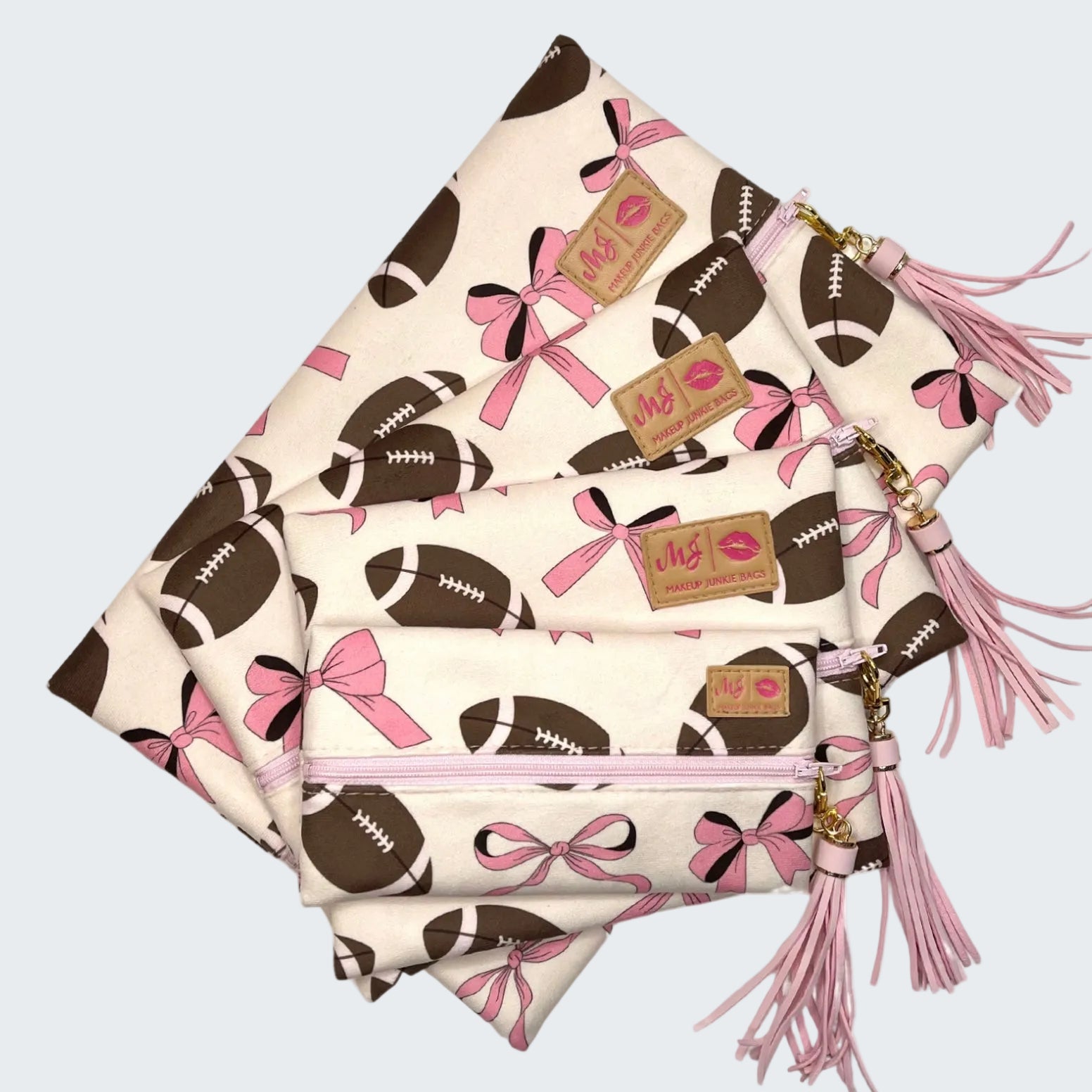 Three pouches with football and bow pattern on a white background