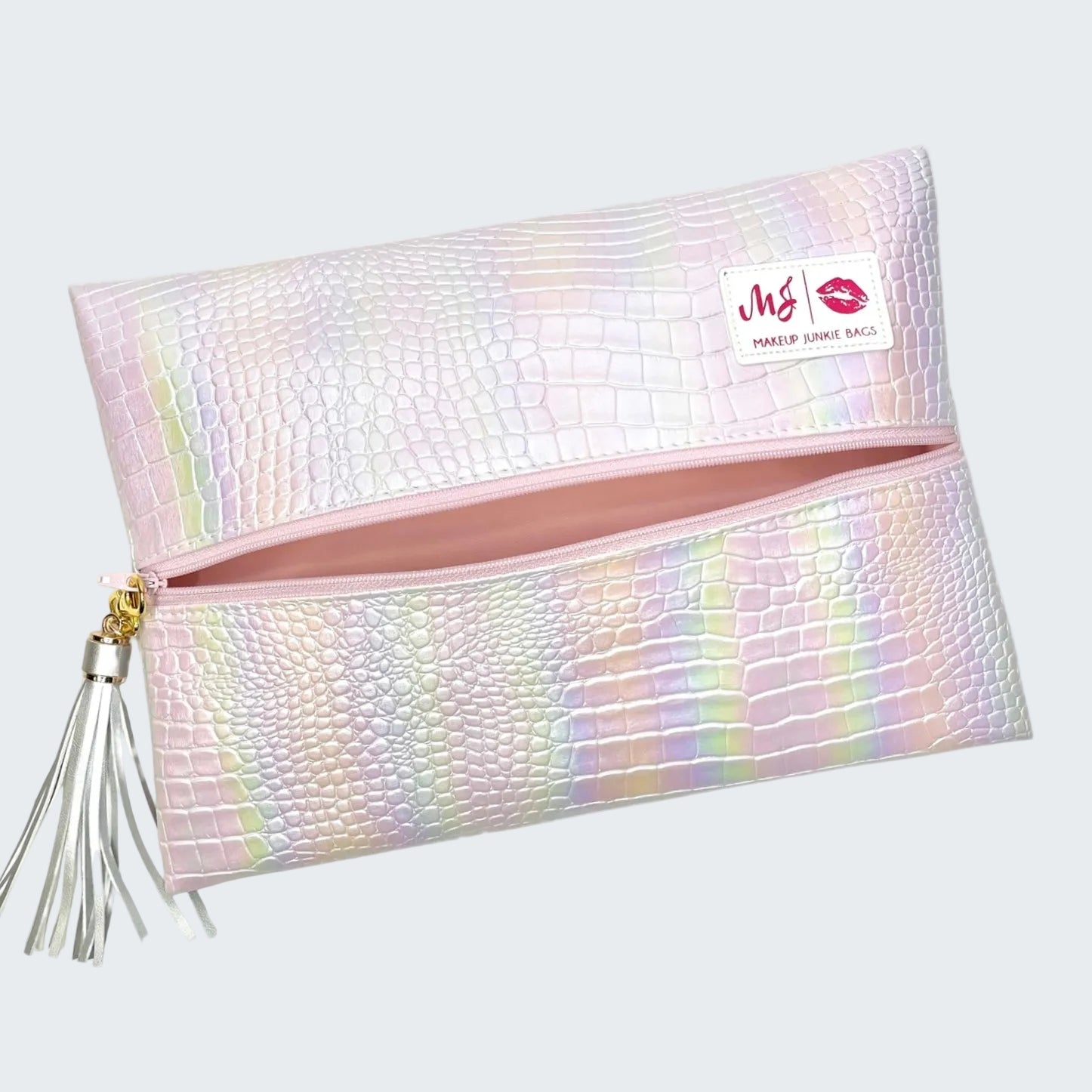 Iridescent makeup bag with tassel on a white background