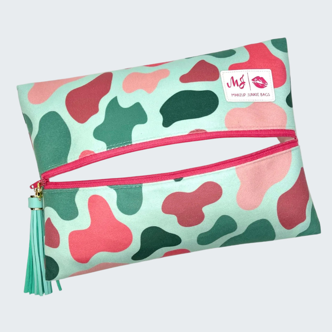 Makeup bag with pink and green abstract pattern on a white background