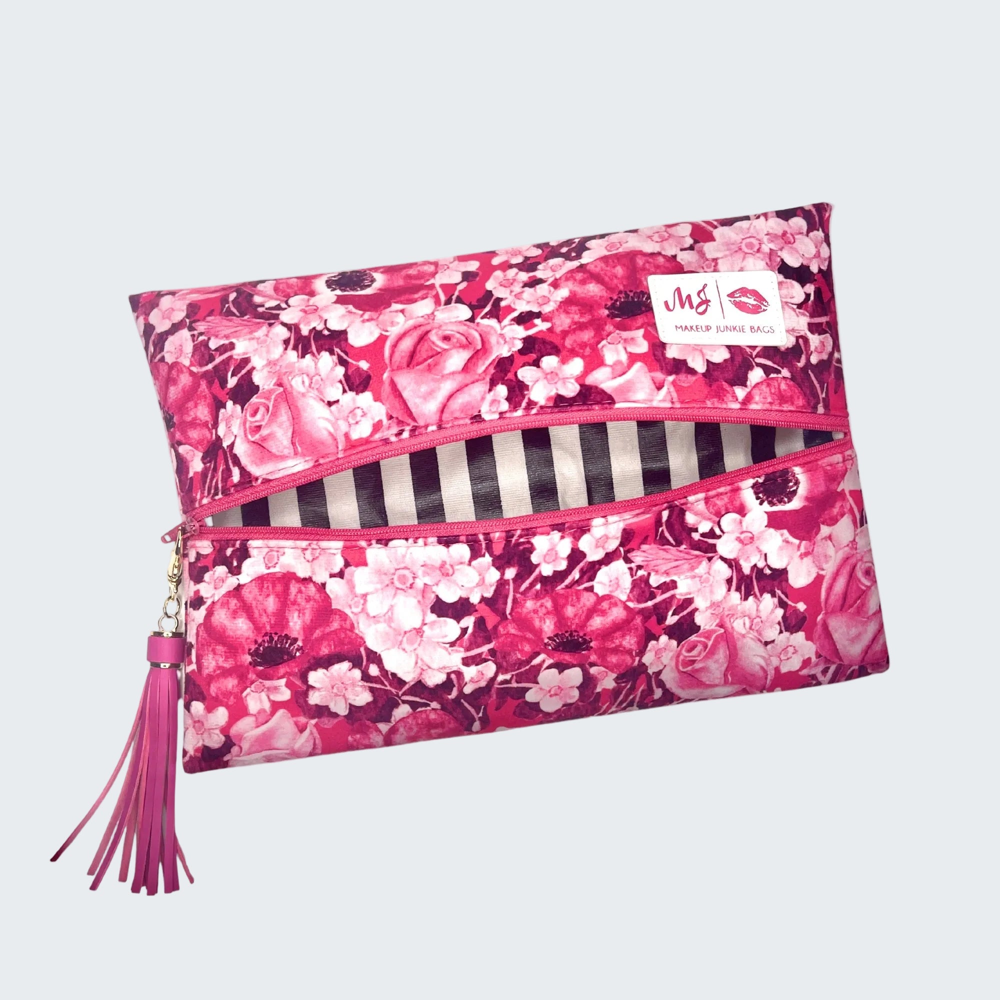 Floral patterned pouch with a tassel on a white background