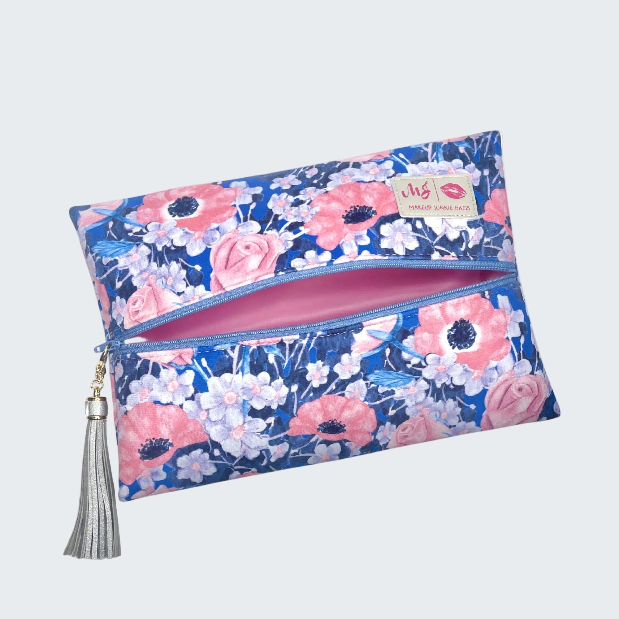 Floral patterned pouch with a tassel on a white background