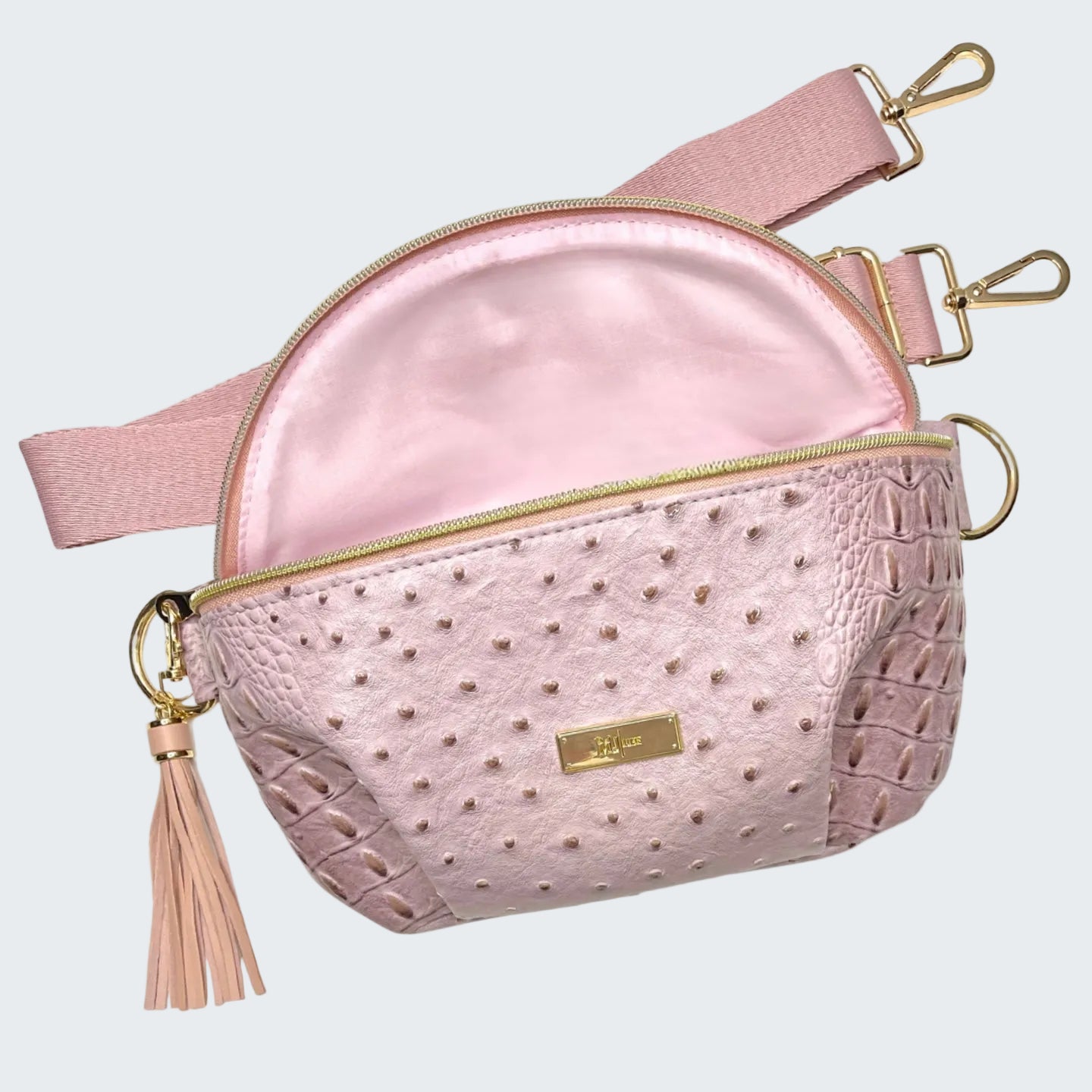 Pink textured crossbody bag with gold accents on a white background