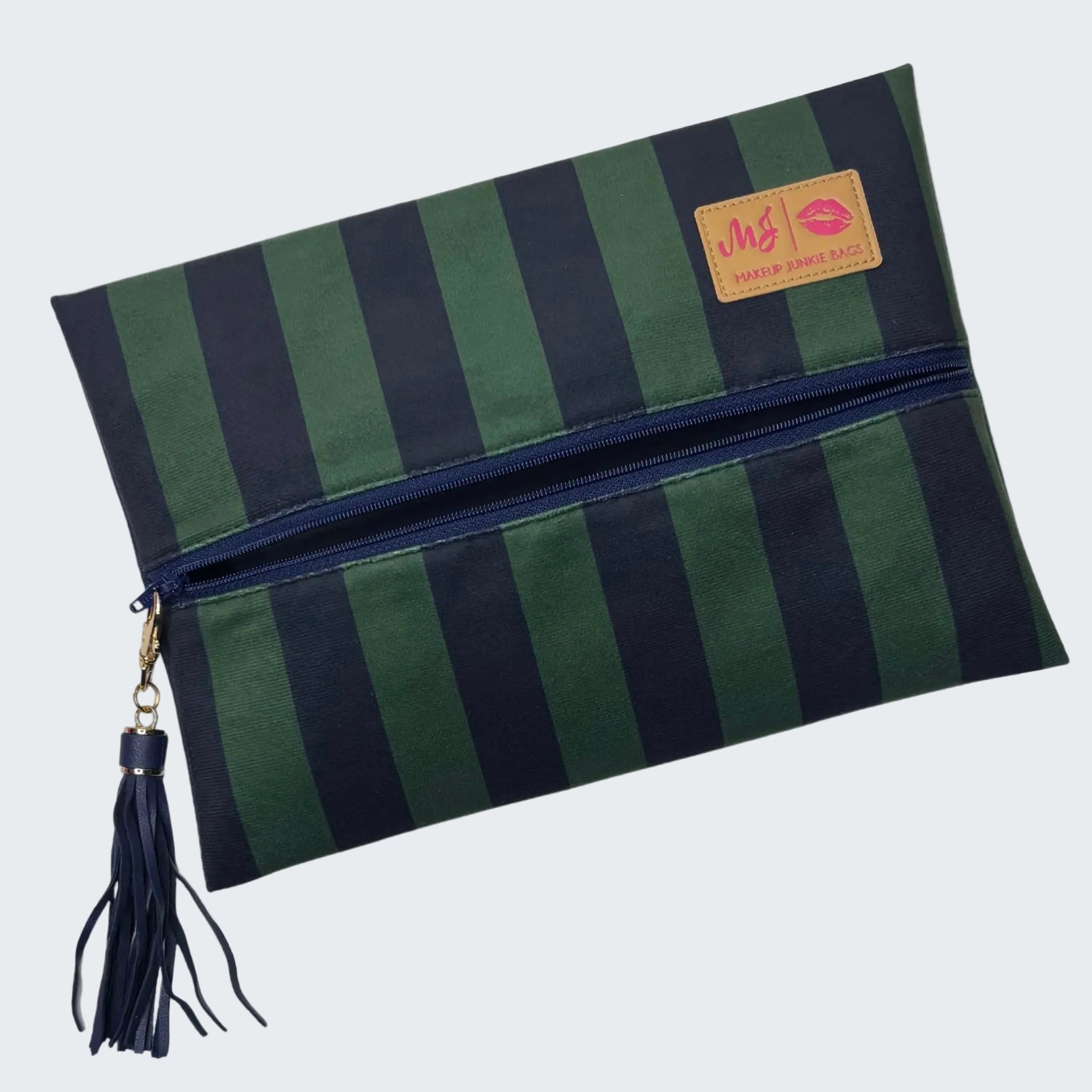 Green and navy striped clutch bag with a tassel on a white background