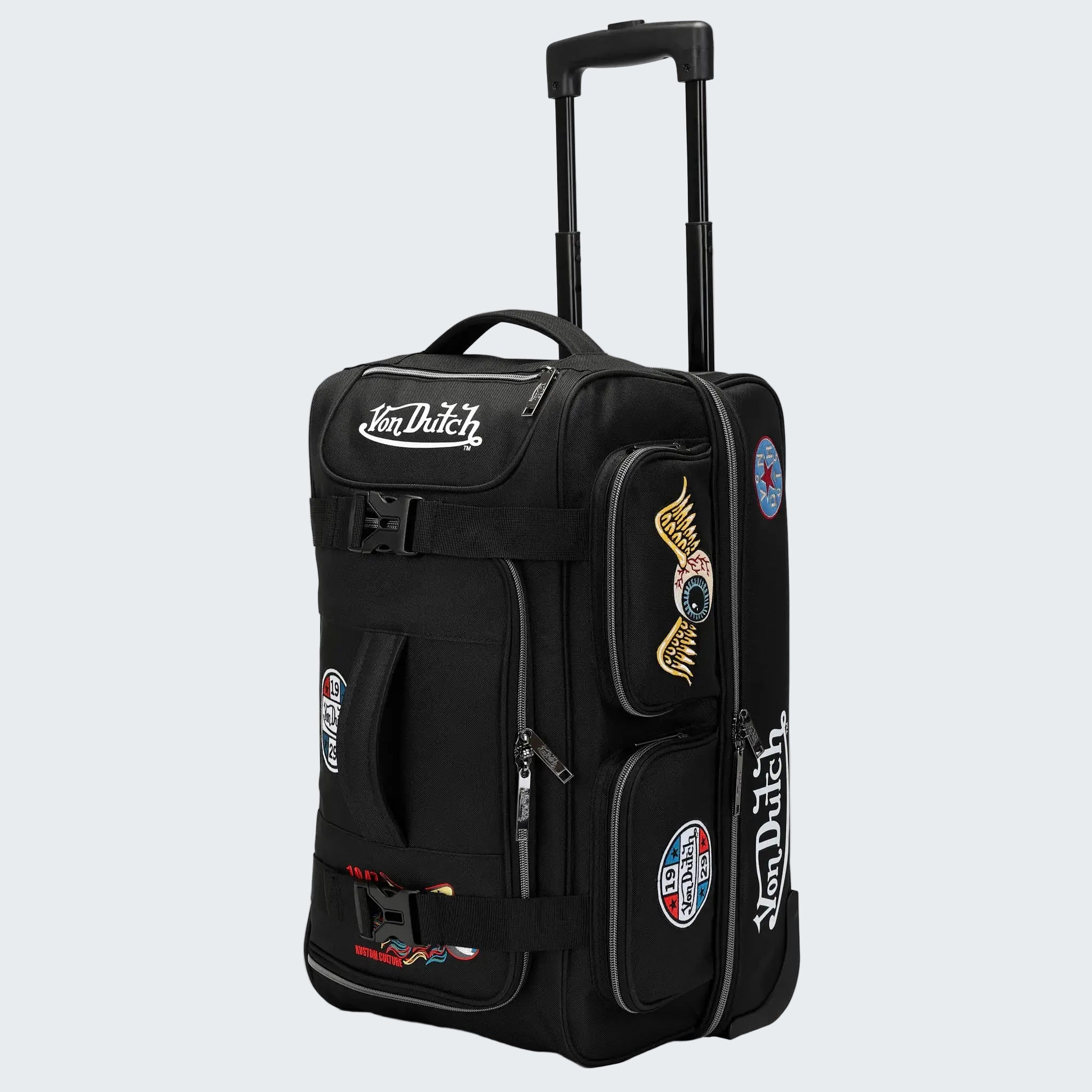 Black rolling suitcase with Von Dutch branding and patches on a white background
