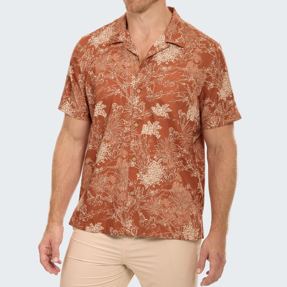 Man wearing a patterned shirt on a white background
