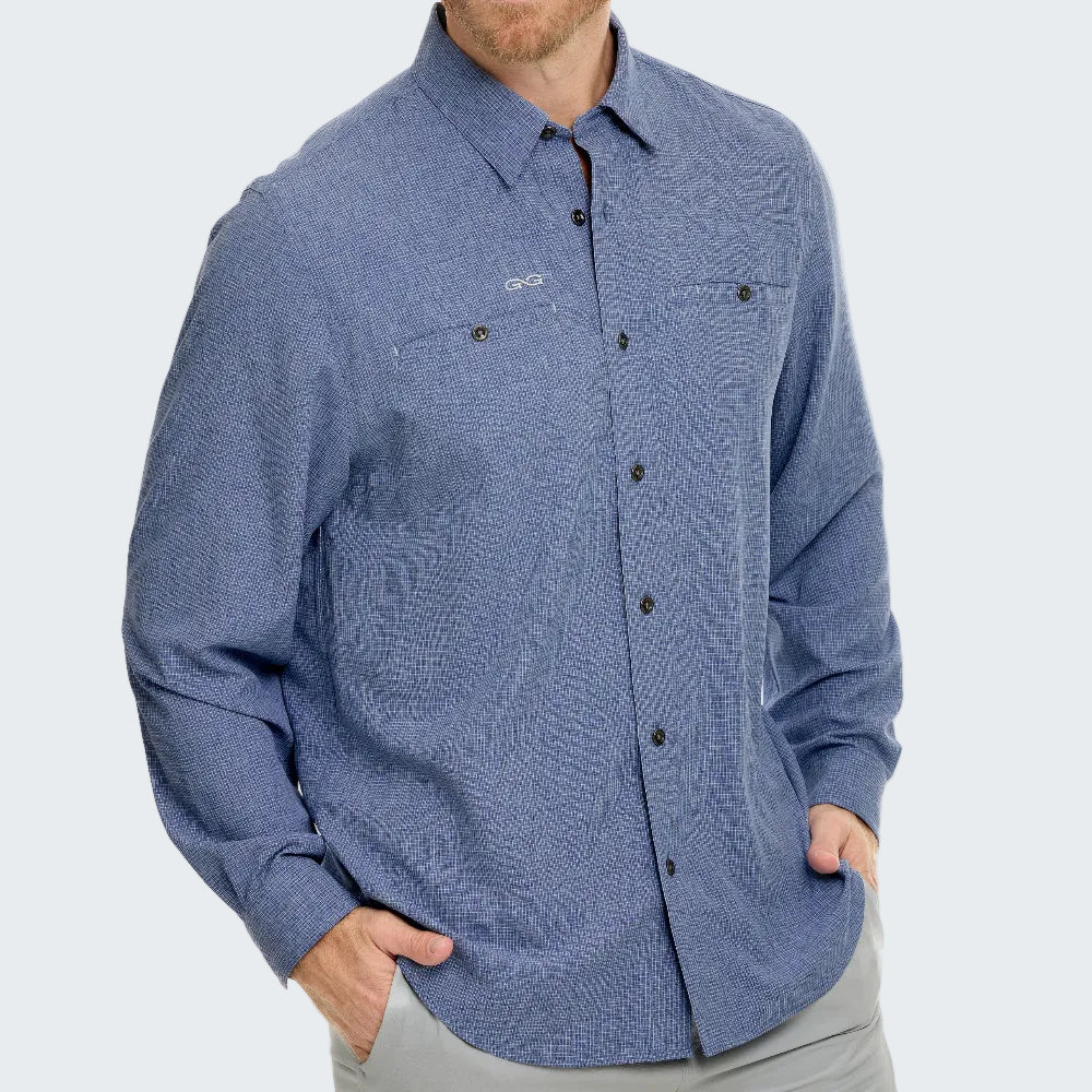 Blue button-up shirt worn by a person on a white background