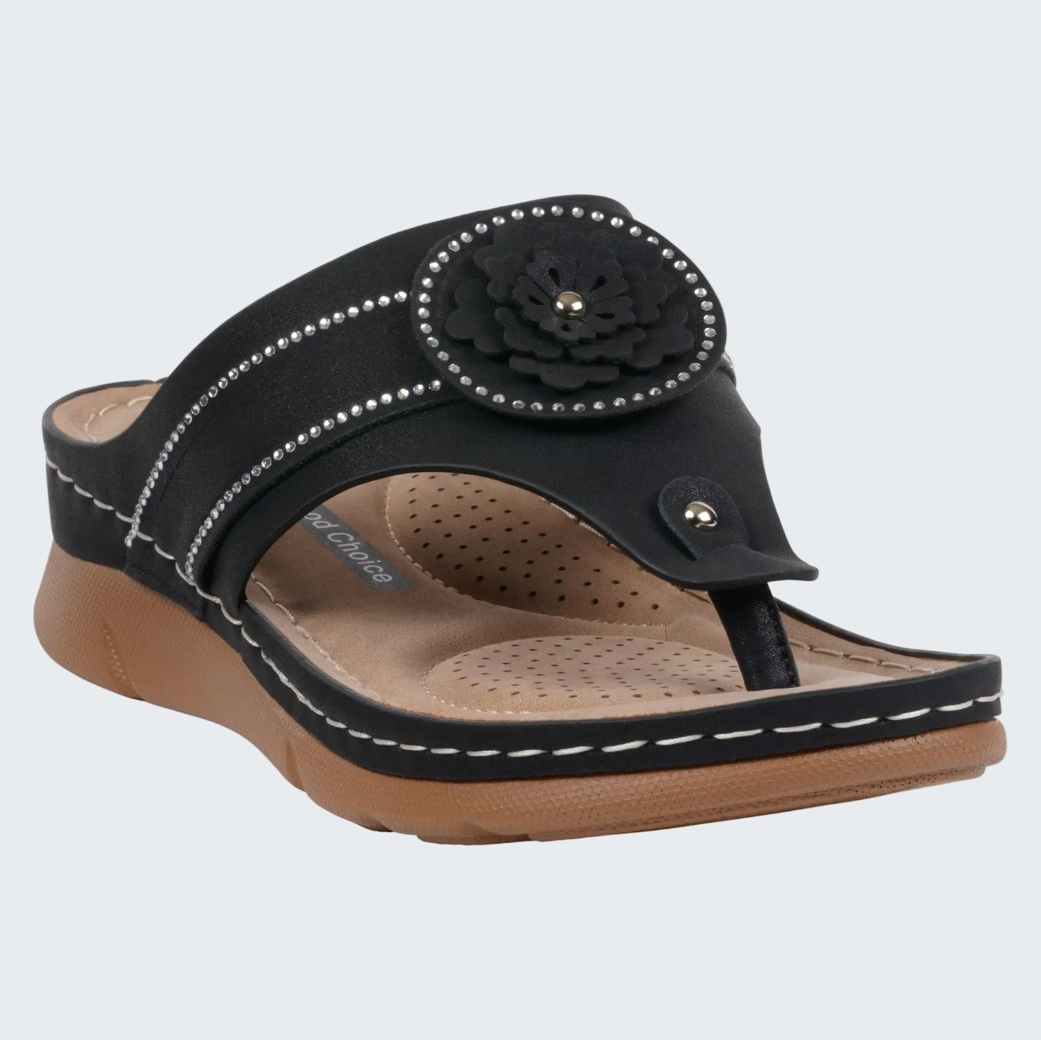 Black sandal with a flower design on a white background