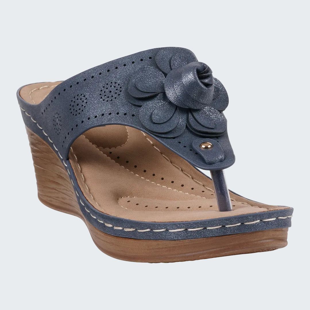 Blue wedge sandal with floral design on a white background